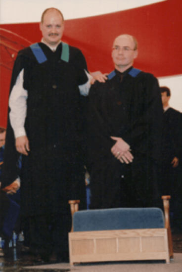 Registrar and Jim Little in covocation gowns in 2003