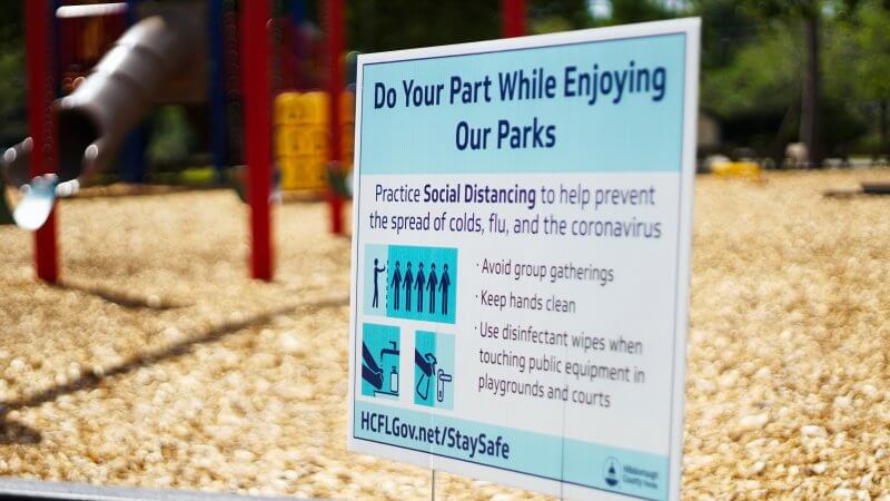 Picture of a social-distancing warning at a playground.