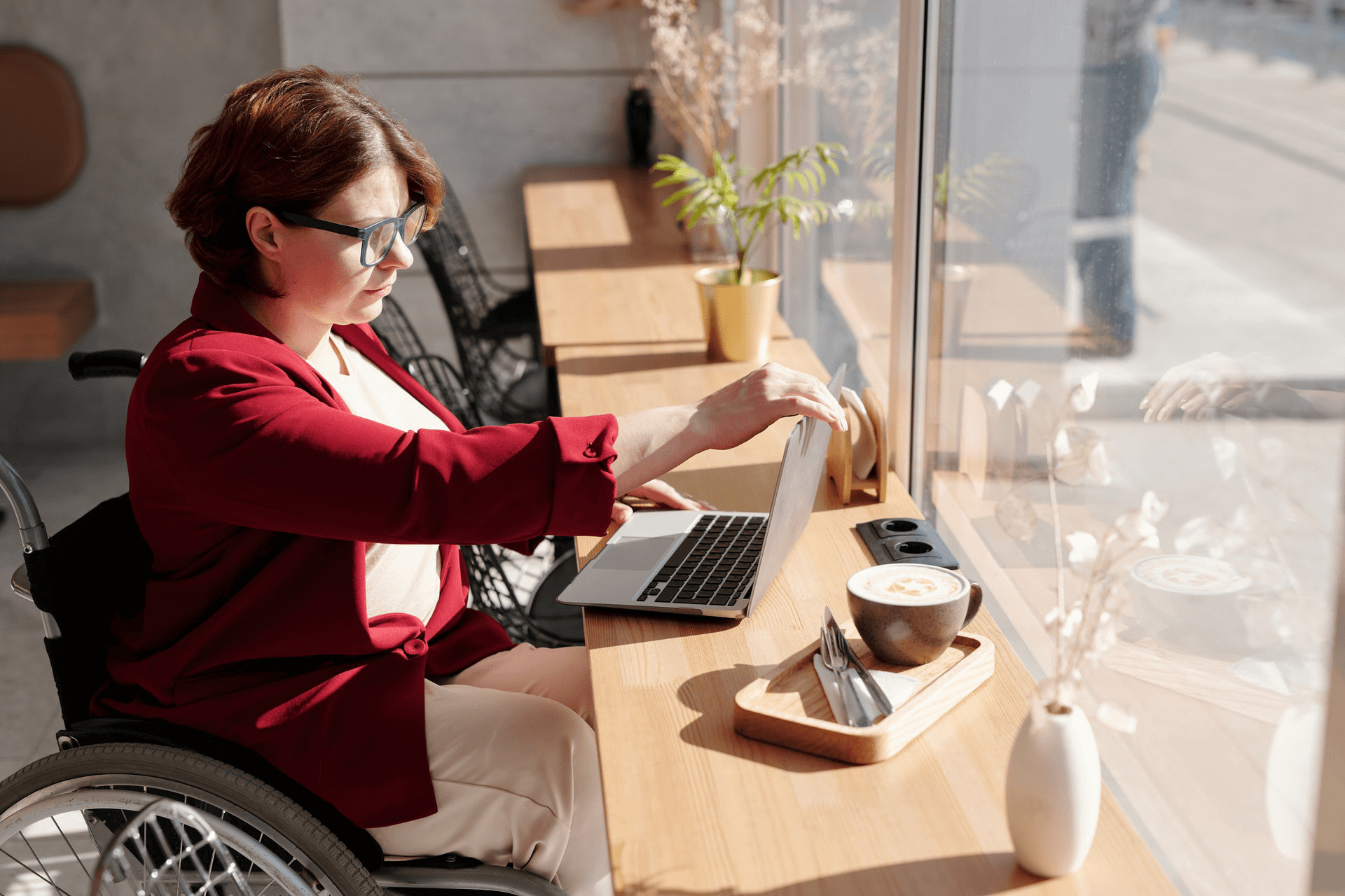 woman in wheelchair using cafe bar seating