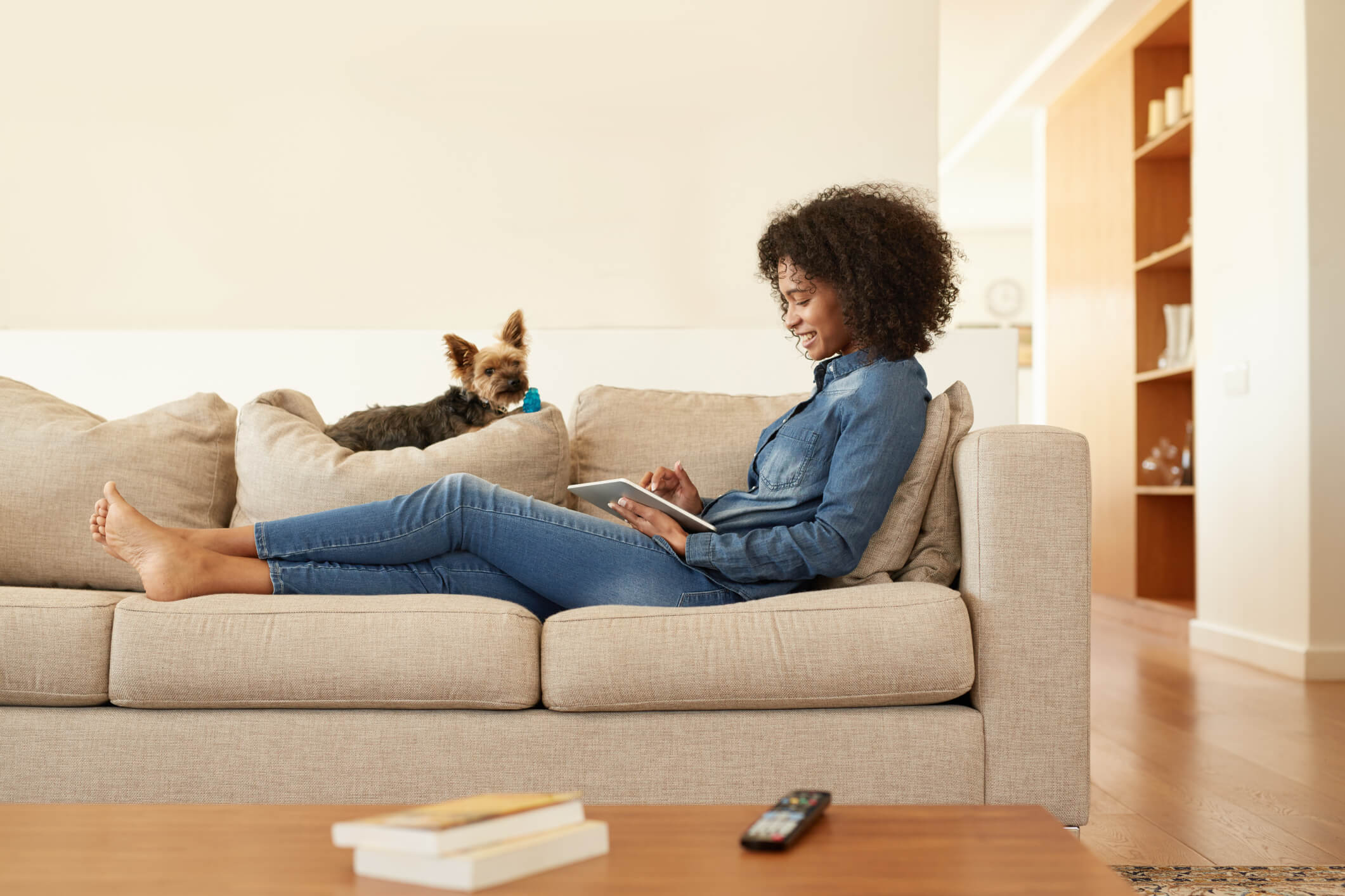 Shot of a young woman relaxing on the sofa with her digital tablet