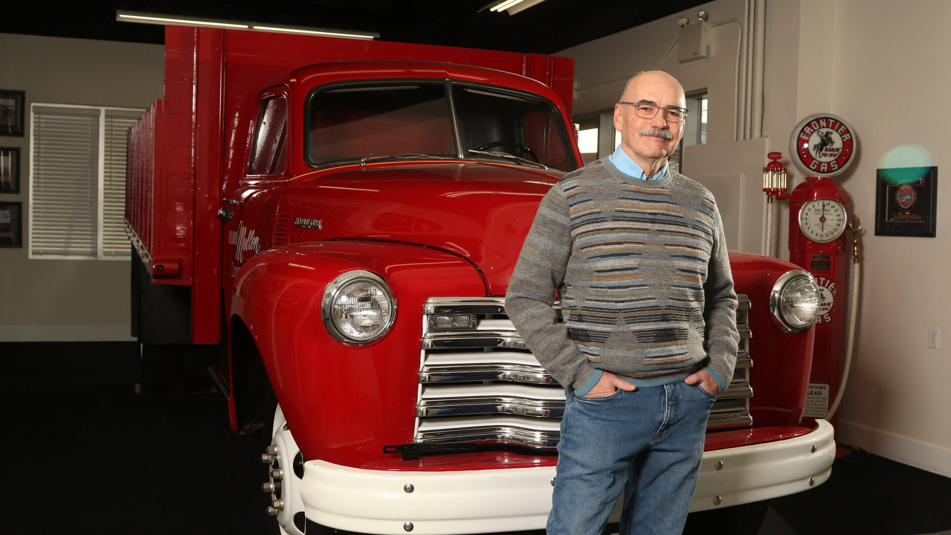 AU MBA grad Jim Little standing in front of an antique truck