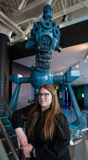 Natasha Donahue stands near an exhibit at TELUS World of Science in Edmonton