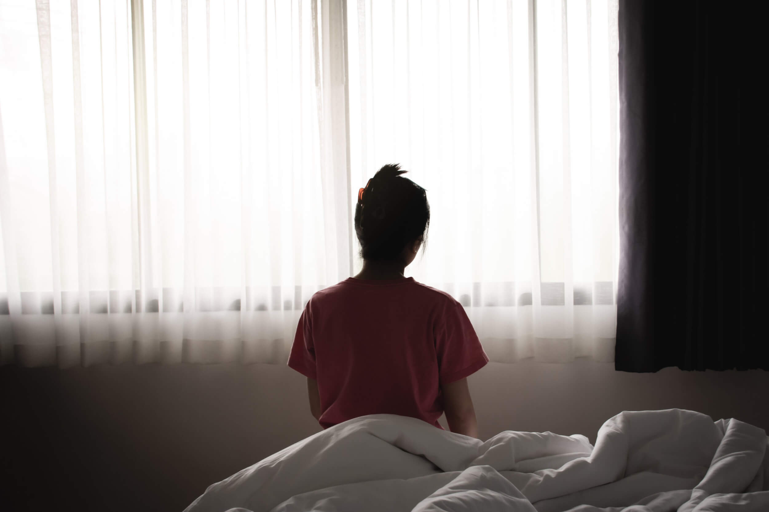 woman sitting on the bed in the morning.
