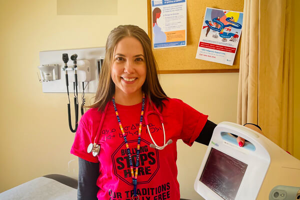 Athabasca University Master of Nursing – Nurse Practitioner grad Kayla Milley in an exam room in Fox Lake, Alberta