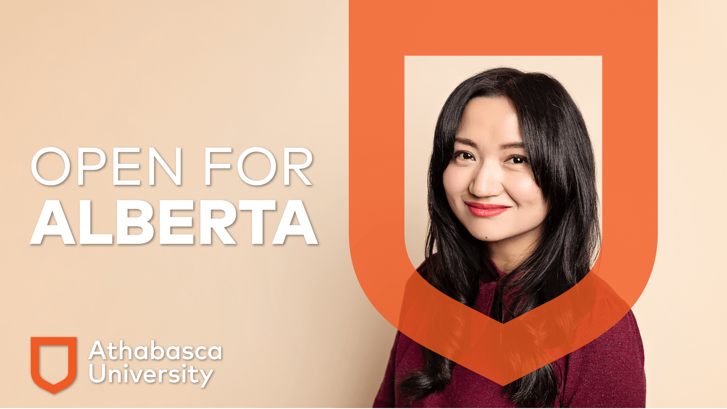 Athabasca University MBA graduate Laurie Wang in front of plain yellow/brown background with Open for Alberta branding.