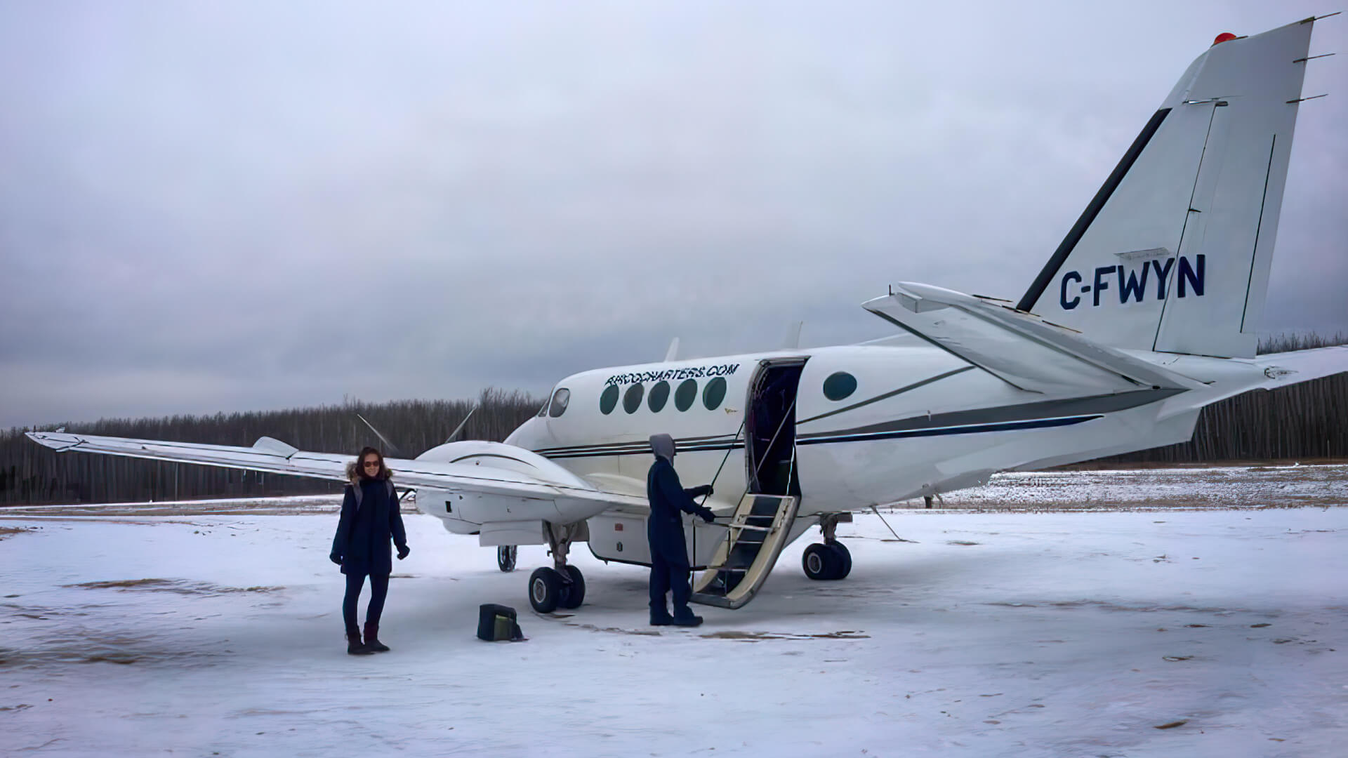 Athabasca University Master of Nursing – Nurse Practitioner grad Kayla Milley about to board a plane at Fox Lake, Alberta during winter.