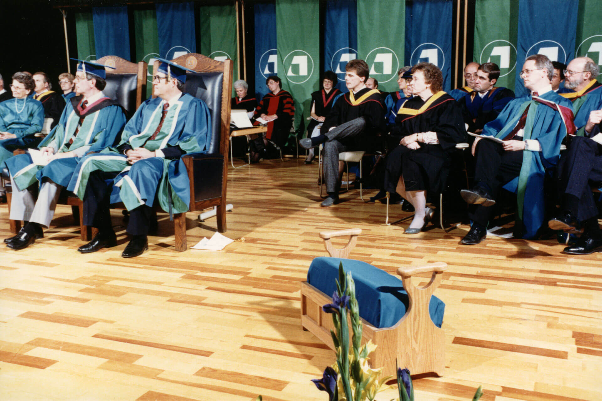 The kneeling stool, shown here in this photo from around 1986, is a ceremonial tradition at convocation ceremonies.