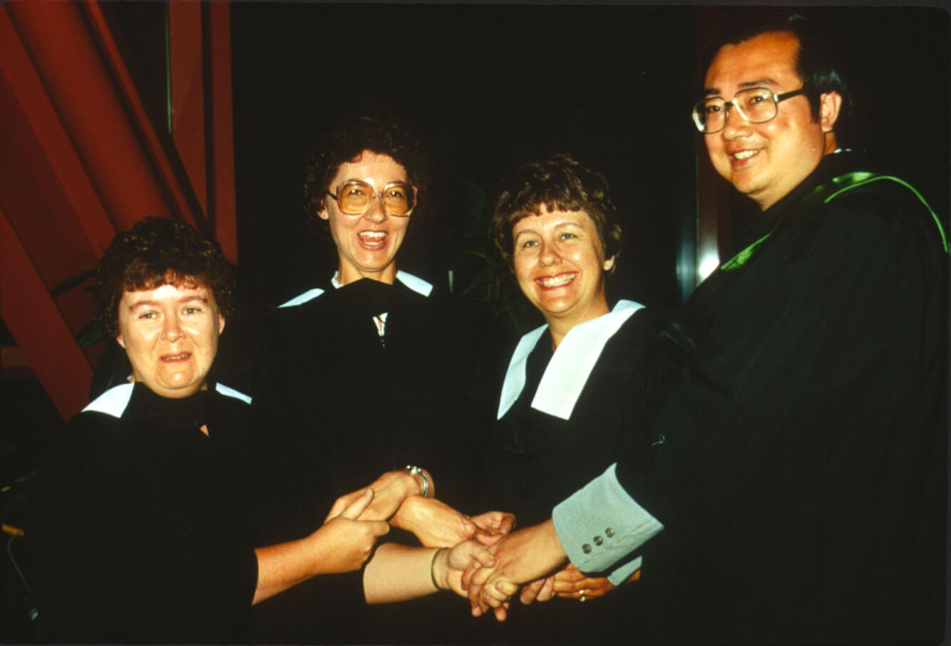 In this photo, taken around 1986, graduates join hands in celebration.