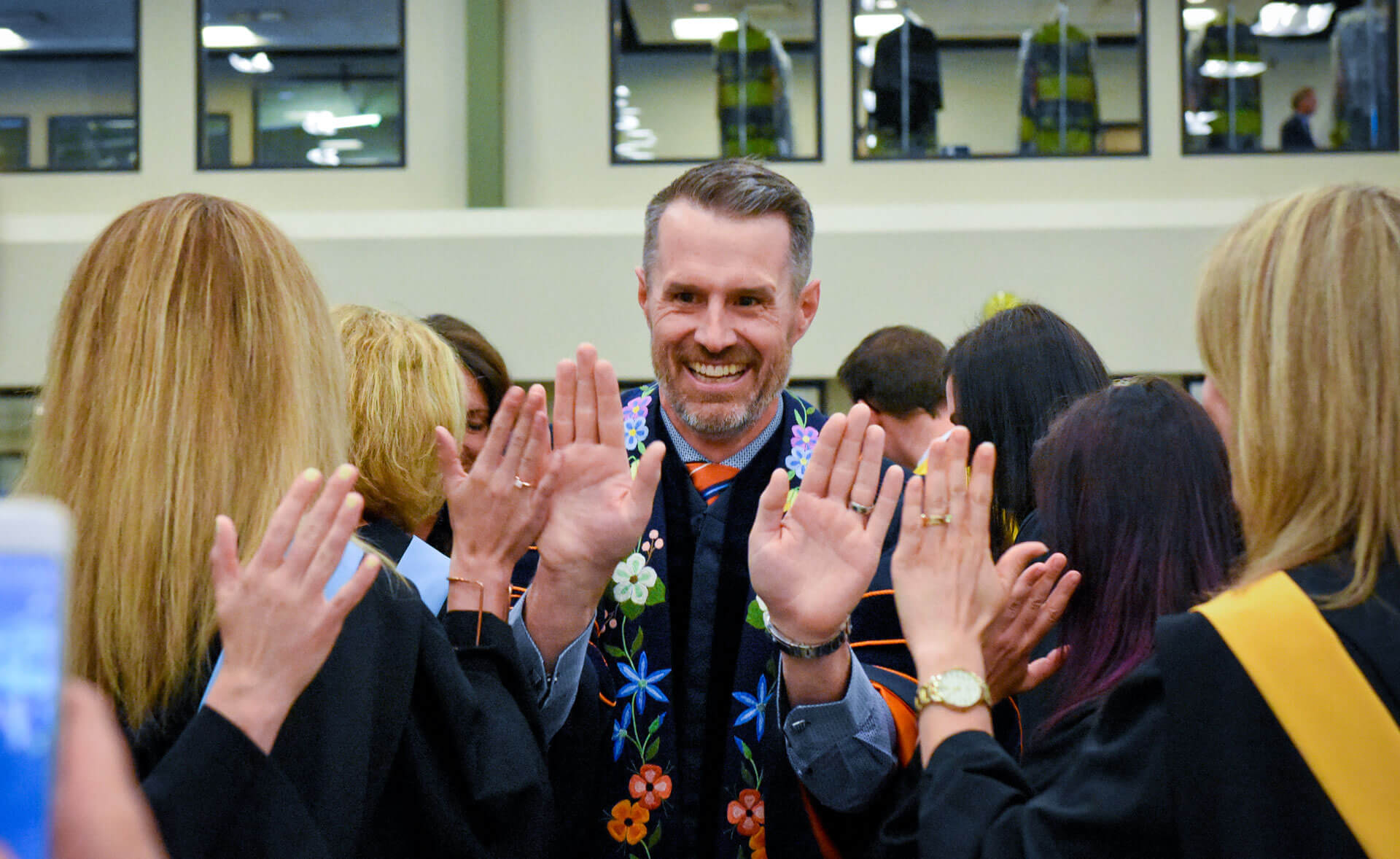 Dr. Neil Fassina, who served as AU president from 2016 until 2021, gives high fives to graduates of the Class of 2018. Fassina made it a tradition to high five all graduates before they crossed the stage.