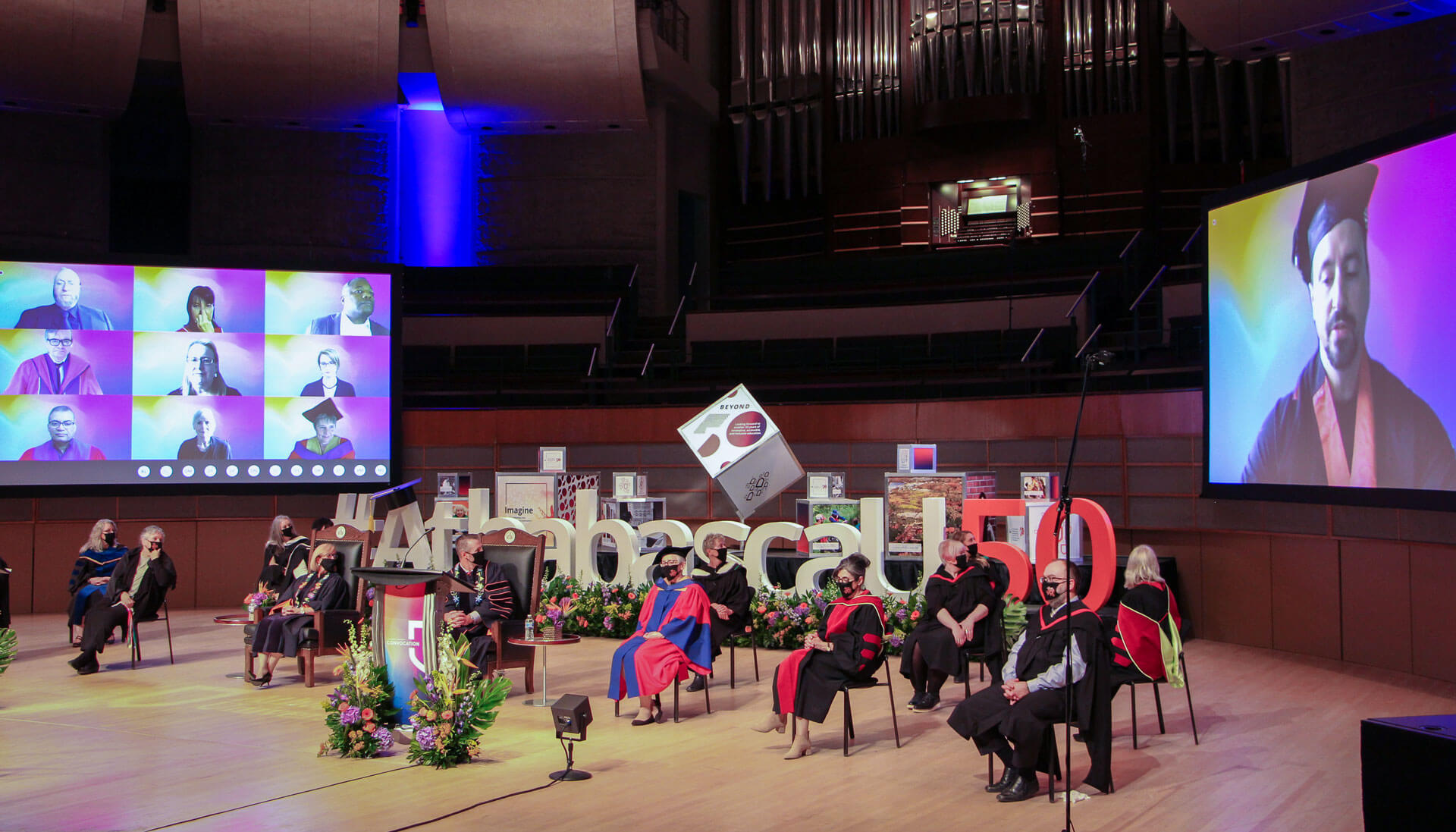 This photo shows the platform party—wearing masks and spaced 2 metres apart—on stage at a recording of the convocation ceremony that was later broadcasted to the graduates.