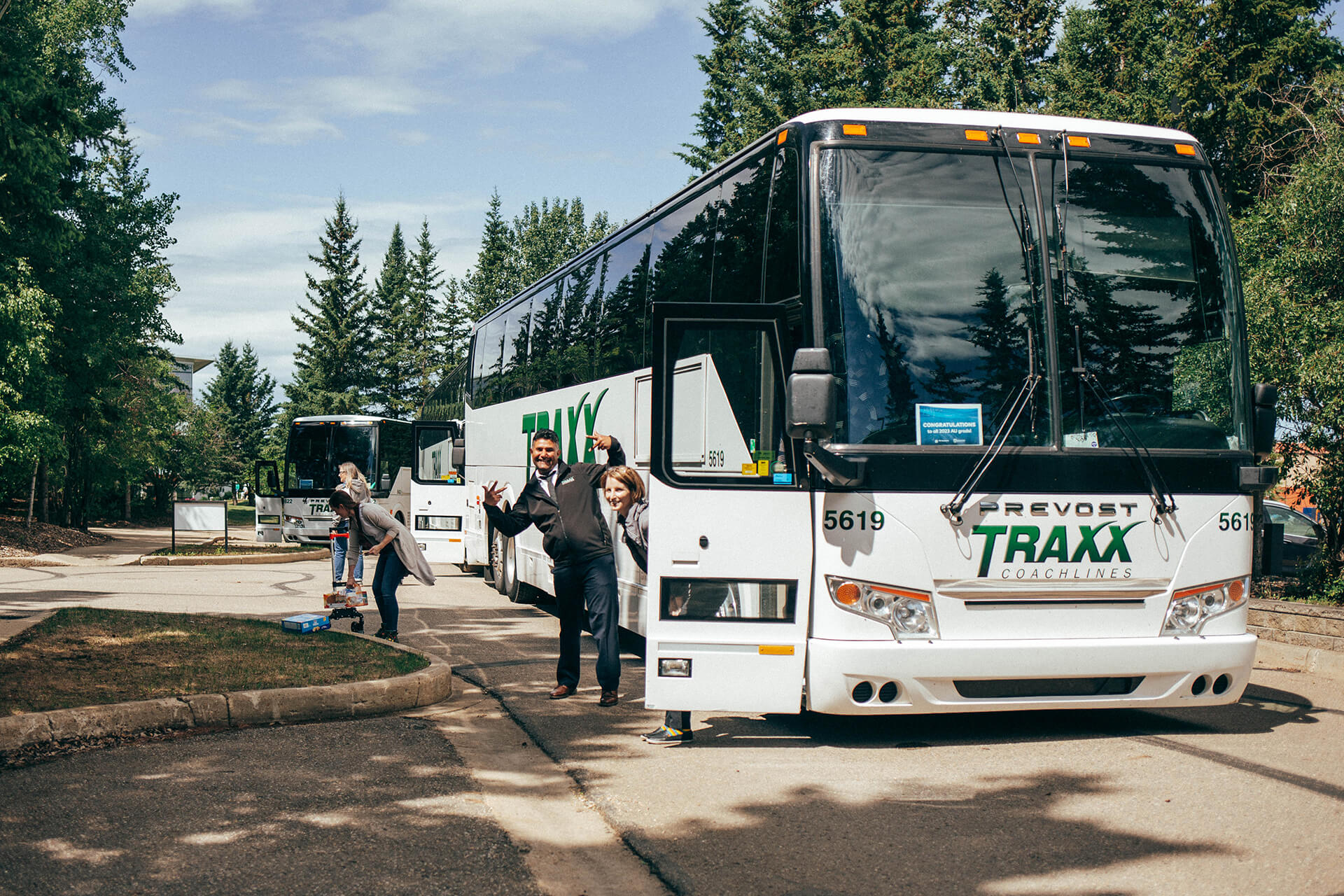 Buses arrive at Athabasca University campus for homecoming on June 18