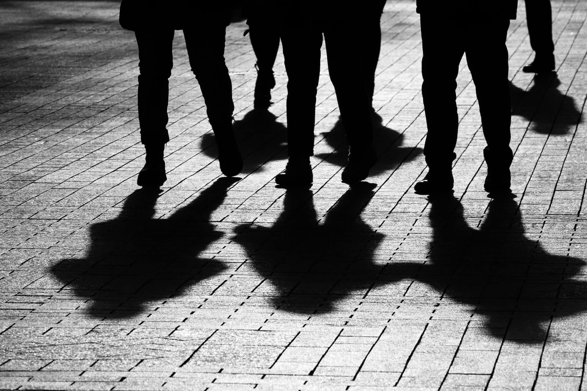 silhouette of legs and shadows on the ground